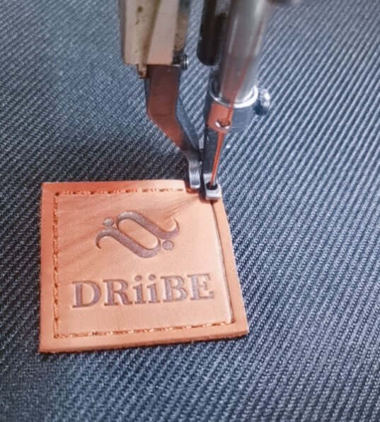 DRiiBE brand label sewing on fabric